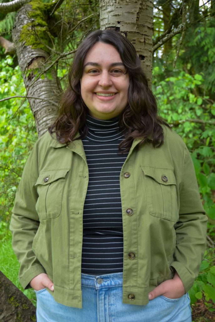 Photo of Margee Quinn, a Seattle telehealth trauma therapist. Margee has wavy brown hair and is smiling.